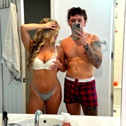 Model in Bathrobe and Underwear with Couple in Bedroom