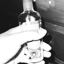 Hand holding a bottle of lotion