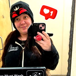 Person taking selfie with phone in bathroom