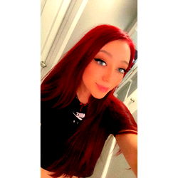 Aunirose, a vibrant and confident red-haired individual