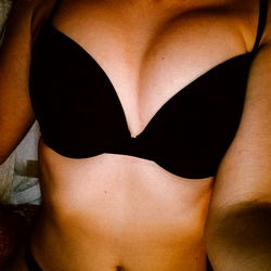 Aleksii, a popular OnlyFans model, poses in black lingerie