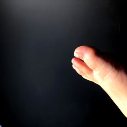 Grace, a model, with one finger extended against the guitar strings in an artistic pose