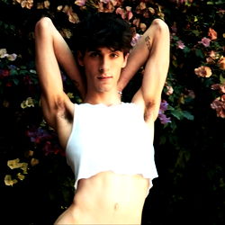 A Young Man in a White Tank Top, Posing for the Camera