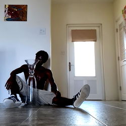 Young Man with Skateboard in Indoor Space