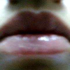 Intimate Close-Up of a Woman's Mouth, with Shiny Lips and Luscious Lipstick