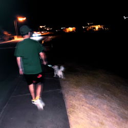 A Man Walking His Dog in the Dark