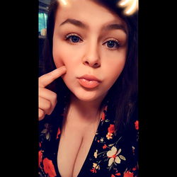 Woman in Floral Dress Smiling at Camera