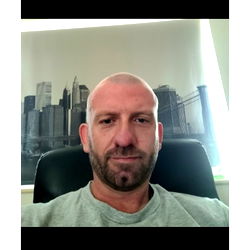 Soleful Man with a Mustache in a Home Office