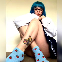 Andie Hart, OnlyFans model with colorful socks and a playful pose in blue hair