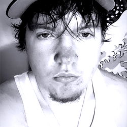 A man posing for a selfie with sunglasses and a baseball cap.