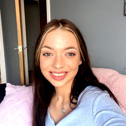Onlyfans Model Jessica in Blue Shirt Smiling at Camera