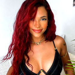 Cleo, A Stunning OnlyFans Model with Long Red Hair and a Daring Ensemble