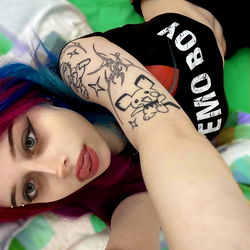 Vivid and colorful OnlyFans model posing on a bed