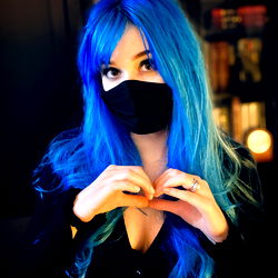 Vibrant Blue Hair with Heart-shaped Hand