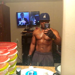 Fitness Model Showcasing Abs and Flexing in Bathroom Mirror