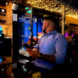 Man in a Bar with an iPhone