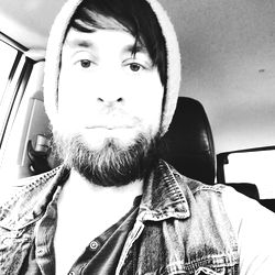 Bearded Man with Hat, Sunglasses and Hoodie in Car