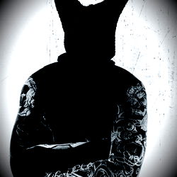 Stylized Black and White Photograph of Onlyfans Model with Tattoos