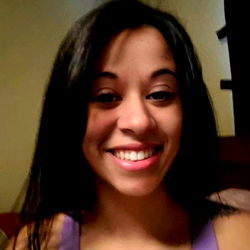 Ann, a charming young woman with a radiant smile, posing confidently in a cozy room. 💫