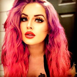 Vivid Makeup and Pink Hair on a Model with Tattoos