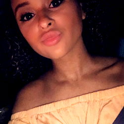 Ally, a captivating OnlyFans model showcases her radiant smile and elegance in this image.