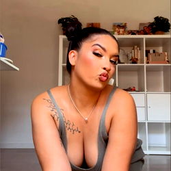 OnlyFans Model ThaBundz Sitting on the Floor in a Sports Bra