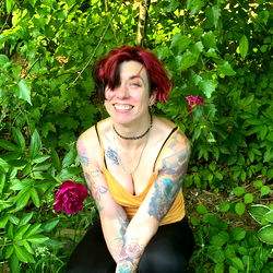 Tattooed Woman Posing in a Garden
